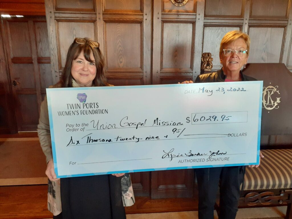 Susan Jordahl-Bubacz, Union Gospel Mission Director, accepts a 2022 grant award check from the TPWF